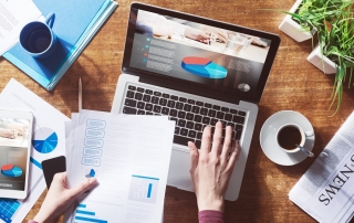 Financial report with pie chart and data on a laptop with business woman's hands at work